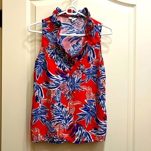Women’s size small sleeveless blouse with ruffle collar.